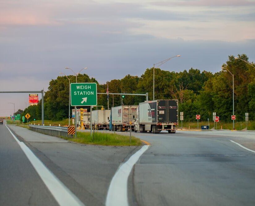 A line of diesel trucks at a weigh station